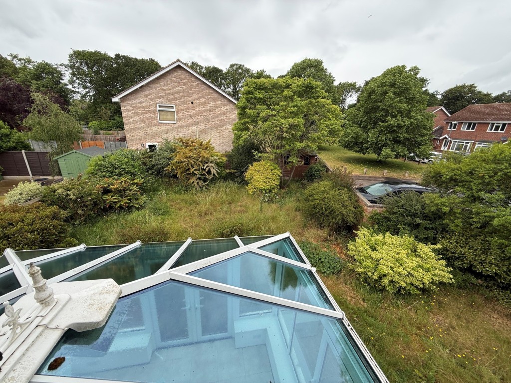 Lot: 114 - THREE-BEDROOM HOUSE FOR IMPROVEMENT AND REPAIR - view of the rear garden and surrounding area.